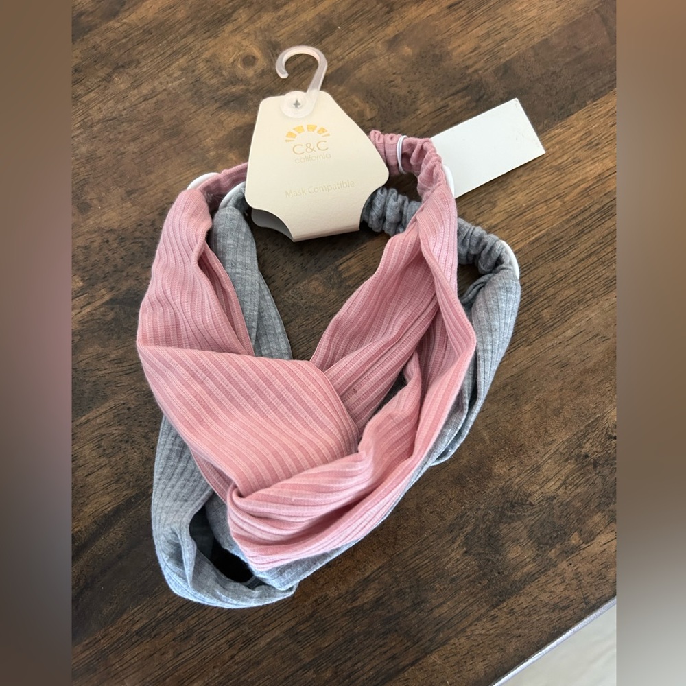 Two pack headbands. Brand new, never worn. One grey, one pink.